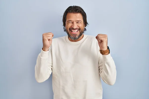 Handsome Middle Age Man Wearing Casual Sweater Blue Background Excited — Stock Photo, Image