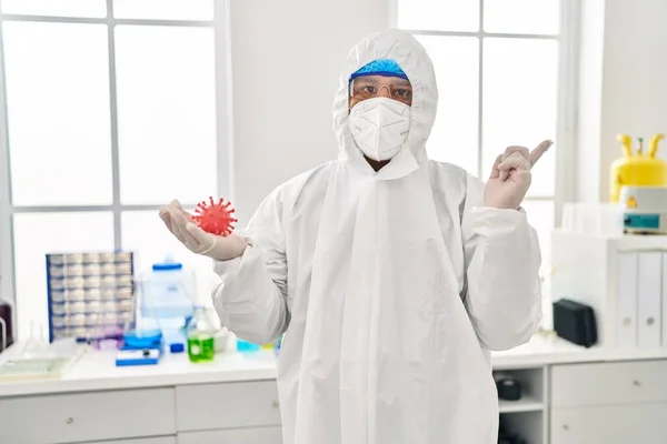 Spaanse Jongeman Werkt Een Laboratorium Met Virusspeelgoed Glimlacht Vrolijk Wijzend — Stockfoto