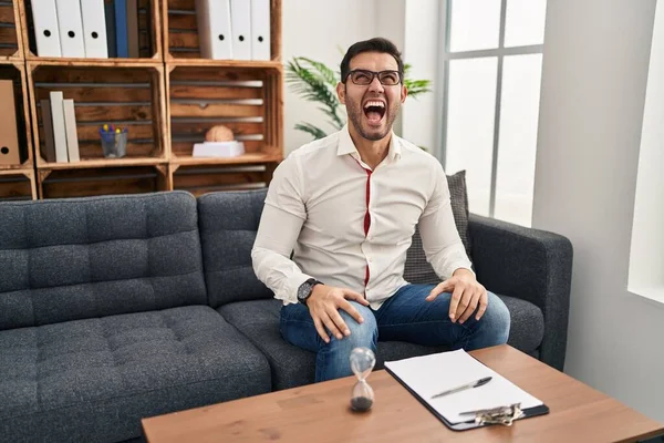 Young Hispanic Man Beard Working Consultation Office Angry Mad Screaming — Stockfoto
