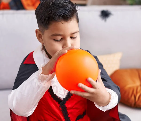 Adorable Hispanic Boy Wearing Halloween Costume Inflating Balloon Home — Stock Photo, Image
