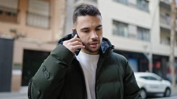 Young Hispanic Man Talking Smartphone Serious Expression Street — 스톡 사진