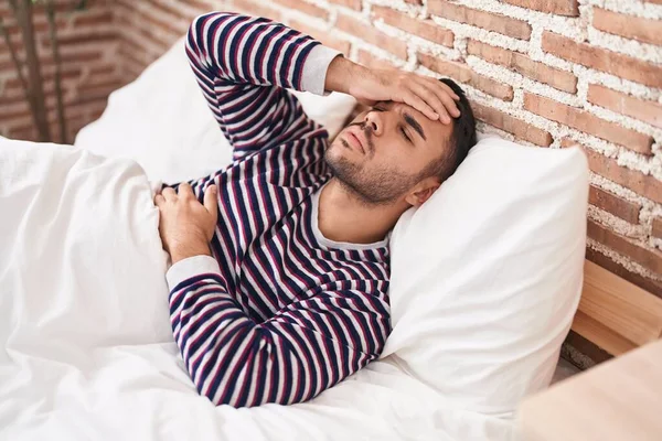 Young Hispanic Man Stressed Lying Bed Bedroom — Stockfoto