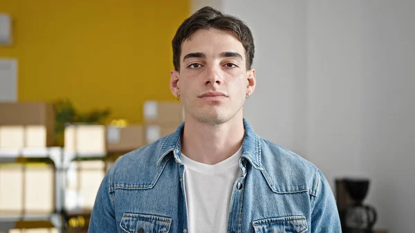 stock image Young hispanic man ecommerce business worker standing with serious expression at office