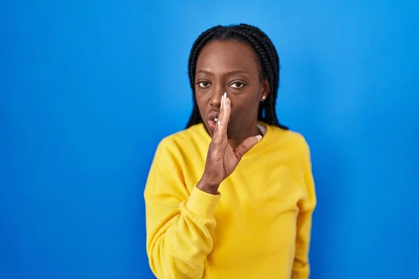Beautiful Black Woman Standing Blue Background Hand Mouth Telling Secret — Stock Photo, Image