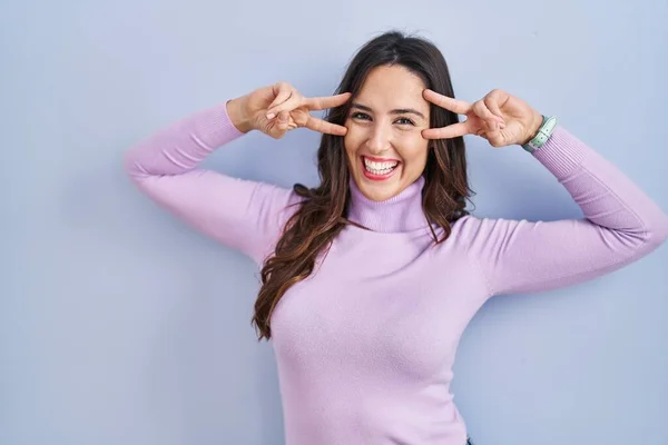 Young Brunette Woman Standing Blue Background Doing Peace Symbol Fingers — Foto Stock