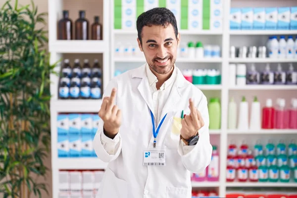 Handsome Hispanic Man Working Pharmacy Drugstore Showing Middle Finger Doing — Zdjęcie stockowe