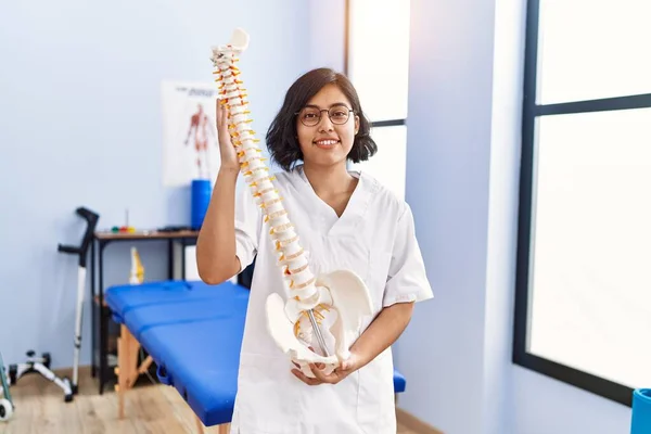 Mladá Latinská Žena Uniformě Fyzioterapeutky Držící Anatomický Model Páteře Fyzioterapeutické — Stock fotografie