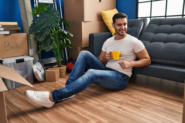 Young Hispanic Man Drinking Coffee Sitting Floor New Home — Stock Photo, Image