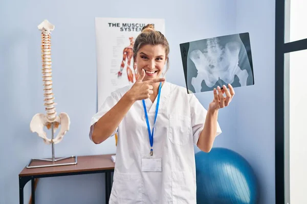 Young Woman Holding Pelvis Radiography Smiling Happy Pointing Hand Finger — Stock Photo, Image