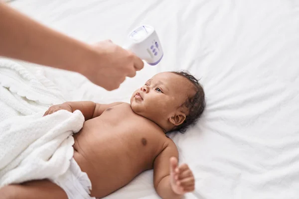 African American Baby Measuring Temperature Bedroom — Stock Photo, Image