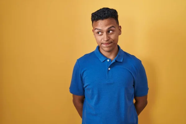 Young Hispanic Man Standing Yellow Background Smiling Looking Side Staring — Foto Stock