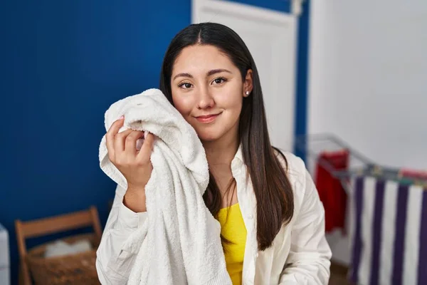 Young Hispanic Woman Touching Face Soft Towel Laundry Room — Stok fotoğraf