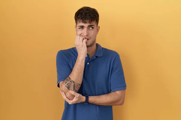 Young Hispanic Man Standing Yellow Background Looking Stressed Nervous Hands — Stock Fotó
