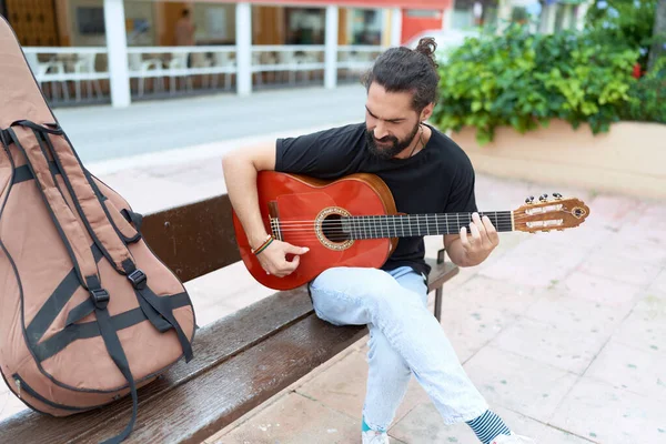 Young Hispanic Man Musician Playing Classical Guitar Sitting Bench Park — Stockfoto