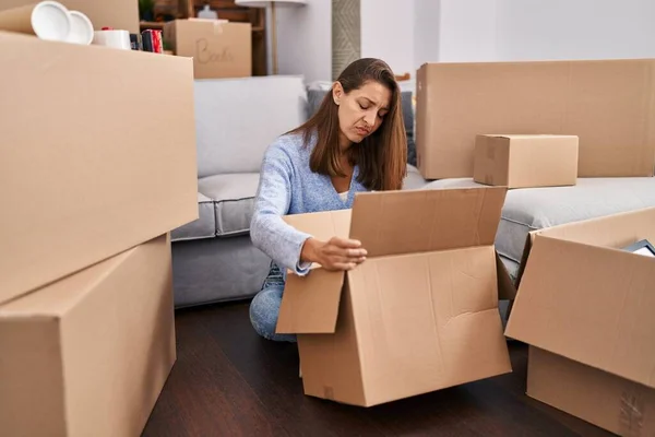 Young Woman Moving New Home Looking Cardboard Box Skeptic Nervous — Fotografia de Stock