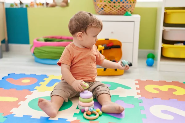Adorable Blond Toddler Playing Hoops Toy Sitting Floor Kindergarten — ストック写真