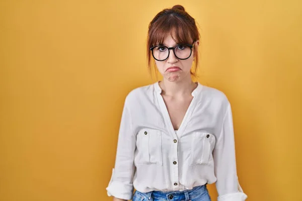 stock image Young beautiful woman wearing casual shirt over yellow background depressed and worry for distress, crying angry and afraid. sad expression. 