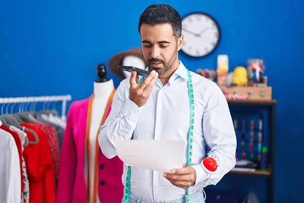 Young Hispanic Man Tailor Talking Smartphone Reading Document Sewing Studio — Fotografia de Stock