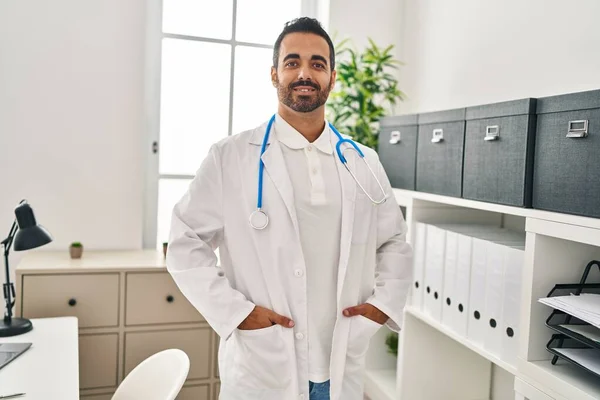 Young Hispanic Man Wearing Doctor Uniform Standing Clinic —  Fotos de Stock