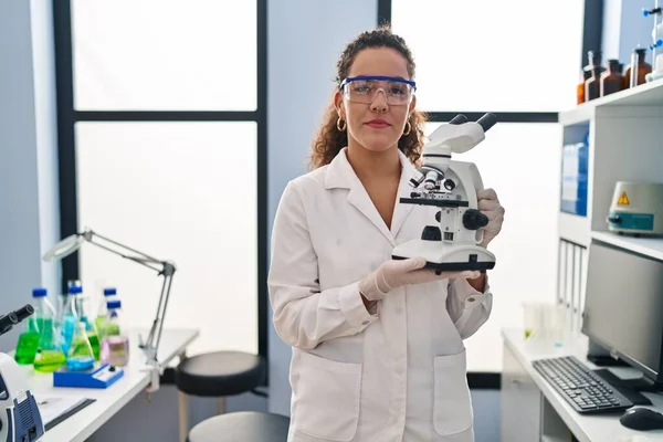 Young Hispanic Woman Working Scientist Laboratory Relaxed Serious Expression Face — Stock Photo, Image