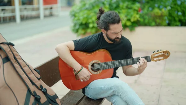 Young Hispanic Man Musician Playing Classical Guitar Sitting Bench Park — Stockfoto