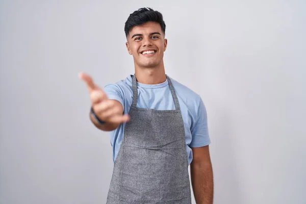 Hispanic Young Man Wearing Apron White Background Smiling Cheerful Offering — Stock Photo, Image