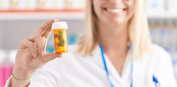Young Blonde Woman Pharmacist Smiling Confident Holding Pills Bottle Pharmacy — Stock Photo, Image