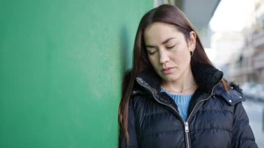 Young caucasian woman standing with serious expression at street