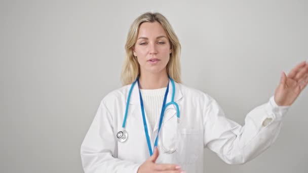 Young Blonde Woman Doctor Making Oath Hand Chest Isolated White — Stock Video