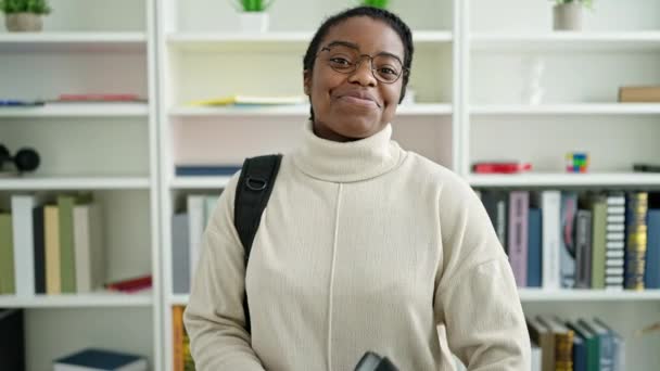 Estudiante Afroamericana Con Mochila Sujetando Carpeta Universidad Biblioteca — Vídeo de stock