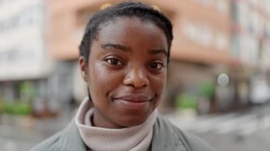 African american woman smiling confident looking to the side at street