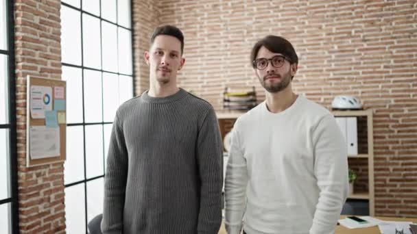 オフィスで腕を組んで立っている二人の男ビジネスパートナーはジェスチャーを交わしました — ストック動画