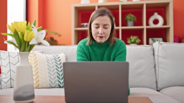 Зріла Іспаномовна Жінка Сірим Волоссям Використовуючи Ноутбук Сидить Дивані Вдома — стокове відео