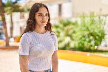 Young woman smiling confident looking to the side at park