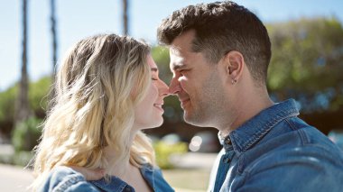 Man and woman couple smiling confident standing together at park