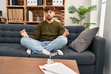Young arab man patient having yoga exercise at psychology center