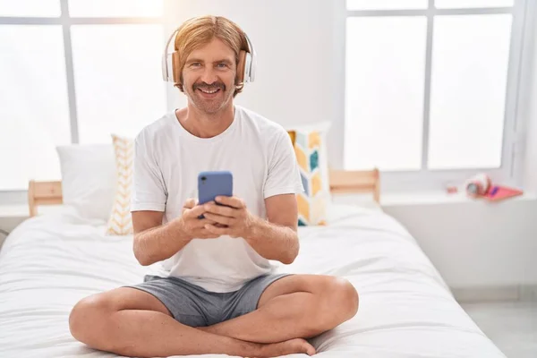 Young Blond Man Listening Music Sitting Bed Bedroom — Stock Fotó