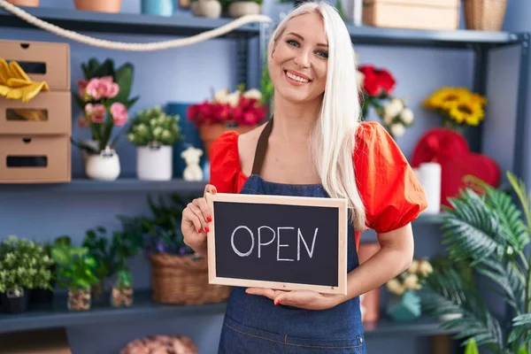 Caucasian woman working at florist holding open sign celebrating crazy and amazed for success with open eyes screaming excited.