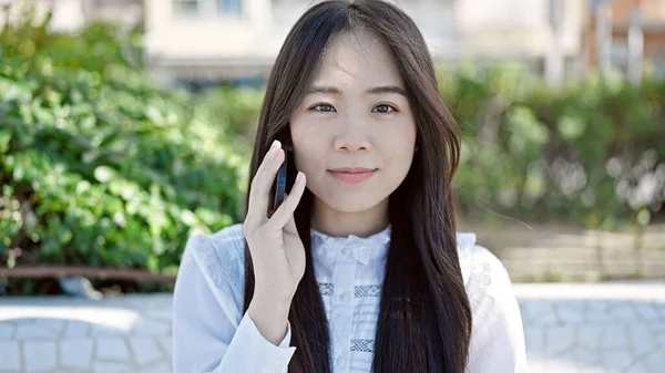 Νεαρή Κινέζα Γυναίκα Μιλάει Στο Smartphone Σοβαρή Έκφραση Στο Πάρκο — Φωτογραφία Αρχείου