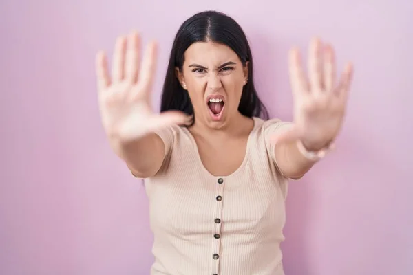 Young Hispanic Woman Standing Pink Background Doing Stop Gesture Hands — Stockfoto