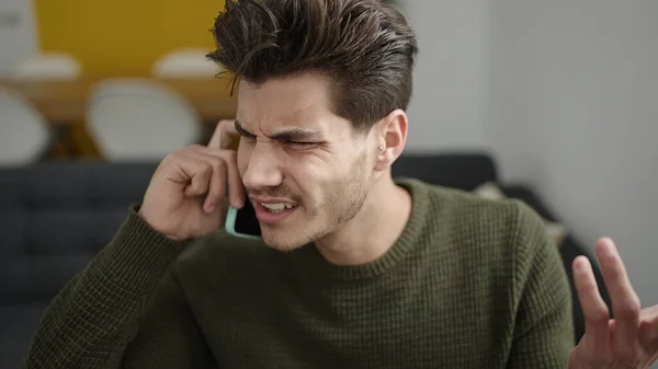 Young Hispanic Man Talking Smartphone Unhappy Expression Home — Photo