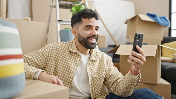 Young Hispanic Man Smiling Confident Sitting Floor New Home — Stockfoto