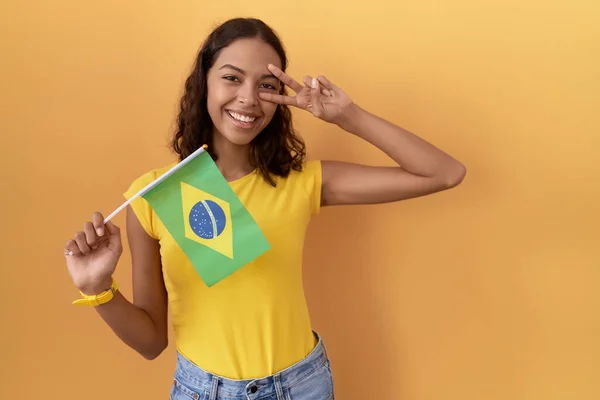 Young Hispanic Woman Holding Brazil Flag Doing Peace Symbol Fingers — Stock Photo, Image
