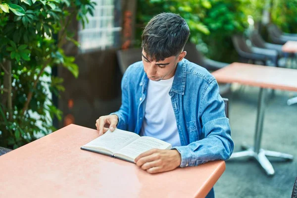 Young Hispanic Man Reading Book Sitting Table Coffee Shop Terrace — Stok fotoğraf
