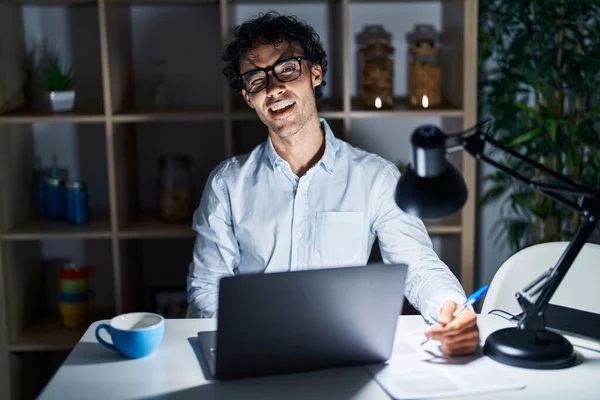 Hispanic Man Working Office Night Winking Looking Camera Sexy Expression — Stock Photo, Image