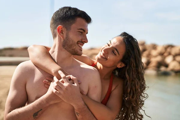 Young Hispanic Couple Tourists Wearing Swimsuit Hugging Each Other Seaside — Photo