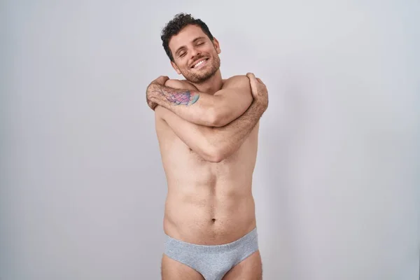 Young Hispanic Man Standing Shirtless Wearing Underware Hugging Oneself Happy — Stock Photo, Image