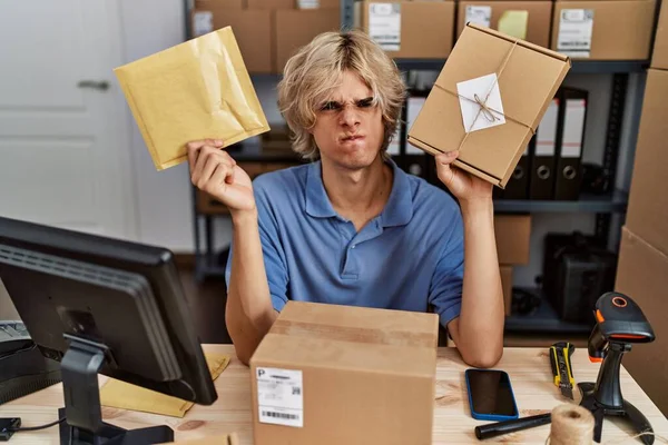 Young Man Working Small Business Ecommerce Holding Packages Skeptic Nervous — Stock Photo, Image