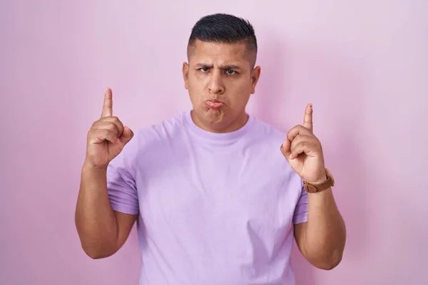 Young Hispanic Man Standing Pink Background Pointing Looking Sad Upset — Stockfoto