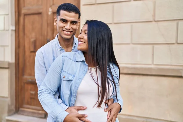 Young Latin Couple Expecting Baby Hugging Each Other Standing Street — Stock fotografie
